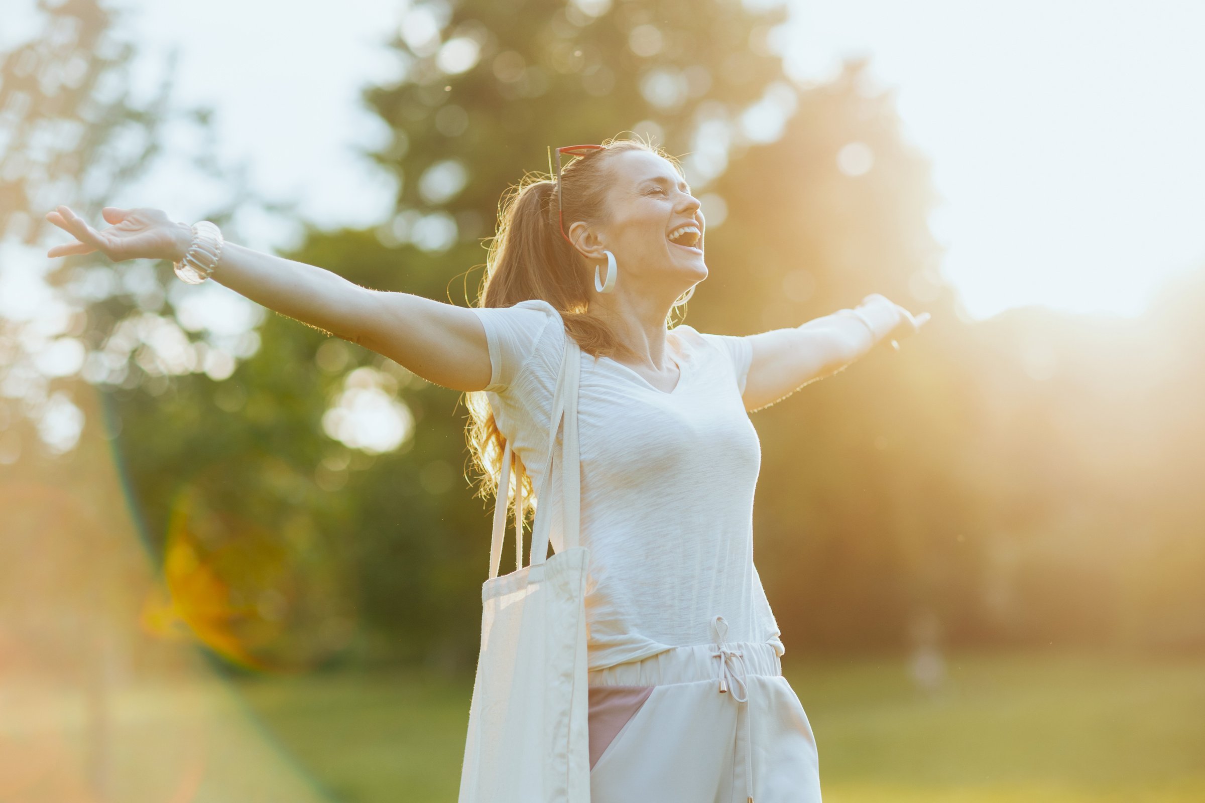 smiling young 40 years old woman in white shirt rejoicing